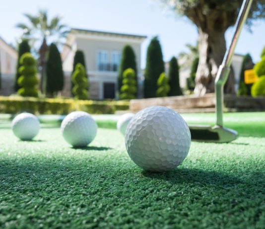 7 Interesting Facts About Mini Golf Mini golf scene with ball and club