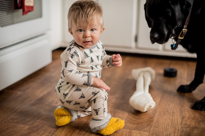 little-boy-playing-with-his-dog-s-bone