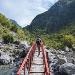 rear-view-of-man-crossing-bridge-accursed-mountain