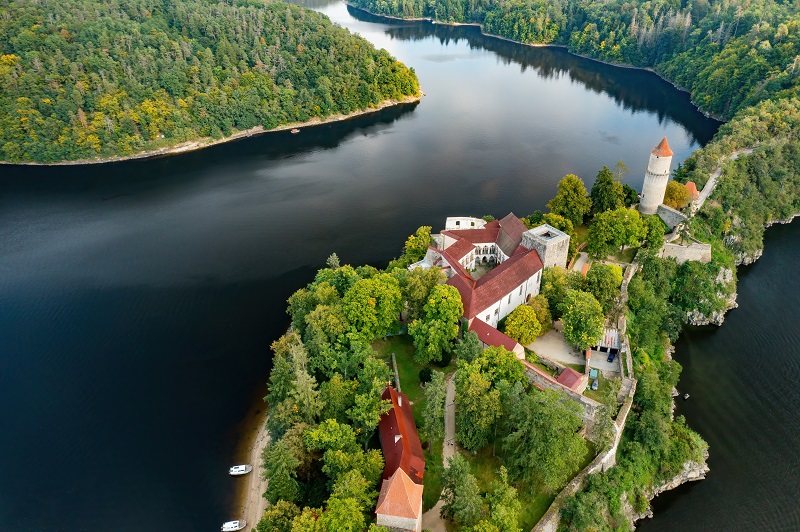 Top view of Zvikov castle with traditional red roofs, river and forest in Czech Republic