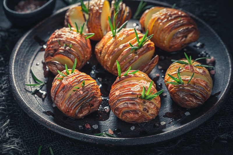 Tasty Hasselback with herbs and oil. Swedish cuisine.